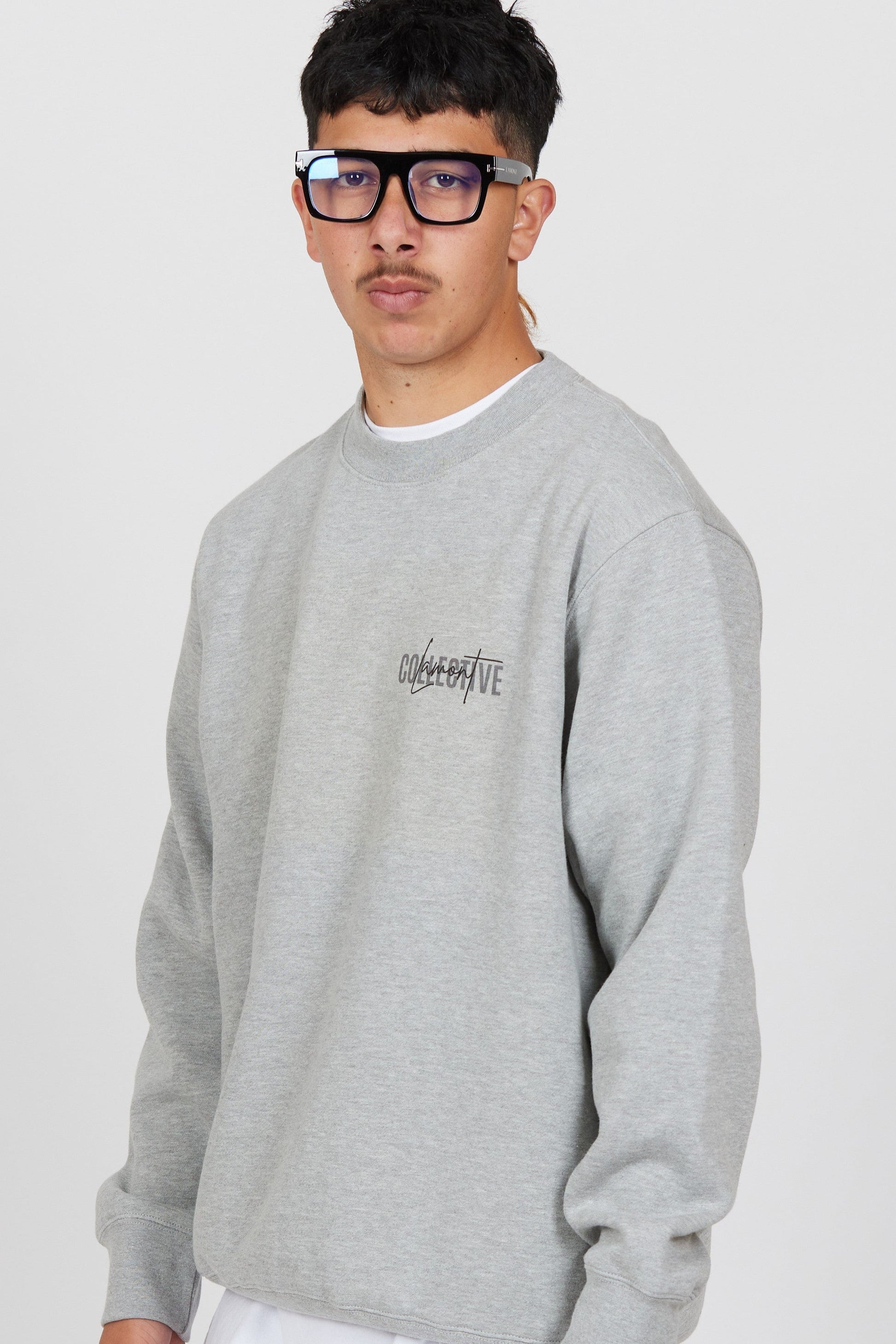 Close Front view of Male model wearing the Grey Marl Collective Crew Neck Top