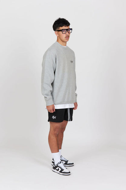 Side view of Male model wearing the Grey Marl Collective Crew Neck Top