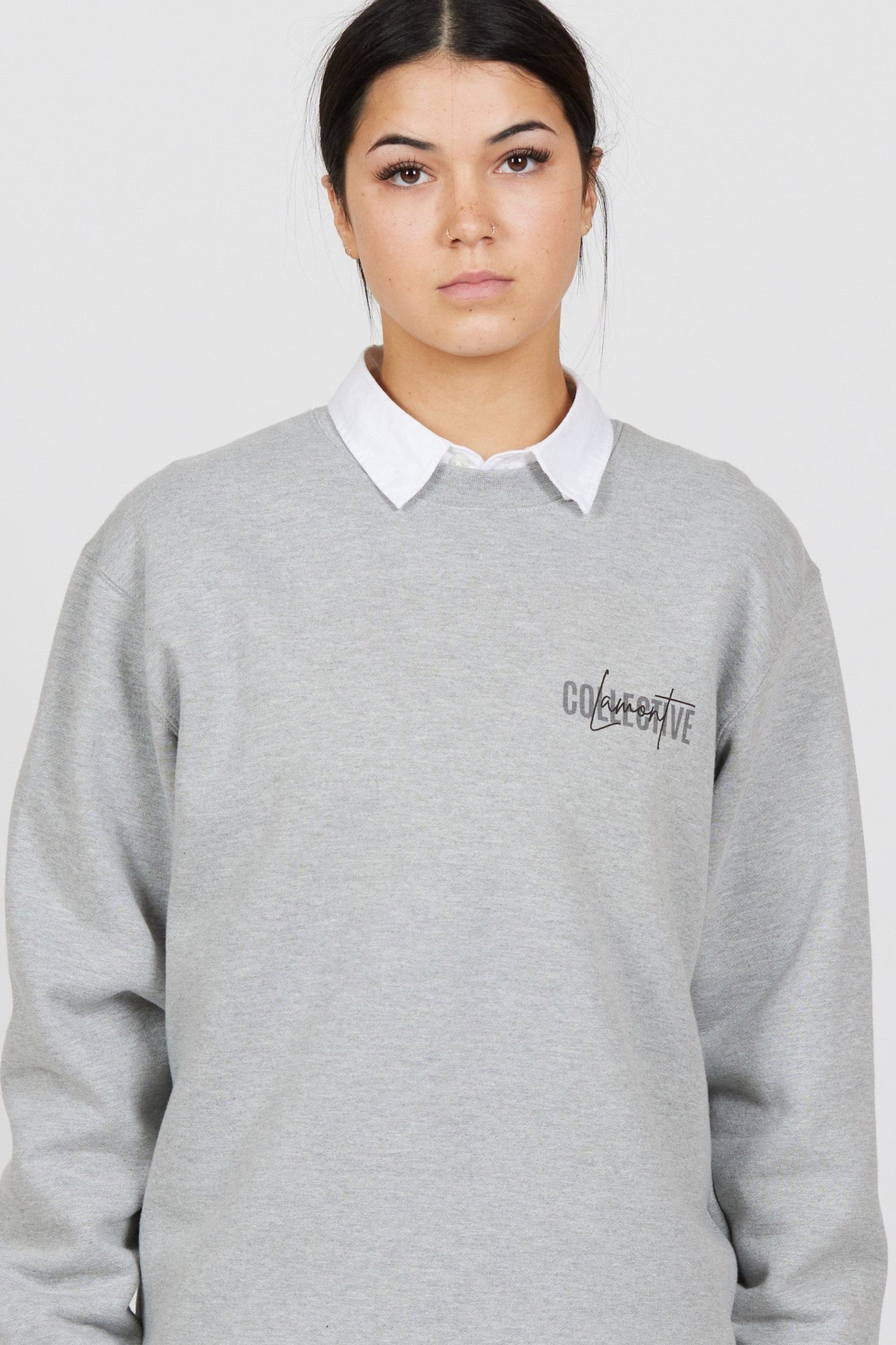 Close up Front view of female model wearing the Grey Marl Collective Crew Neck Top