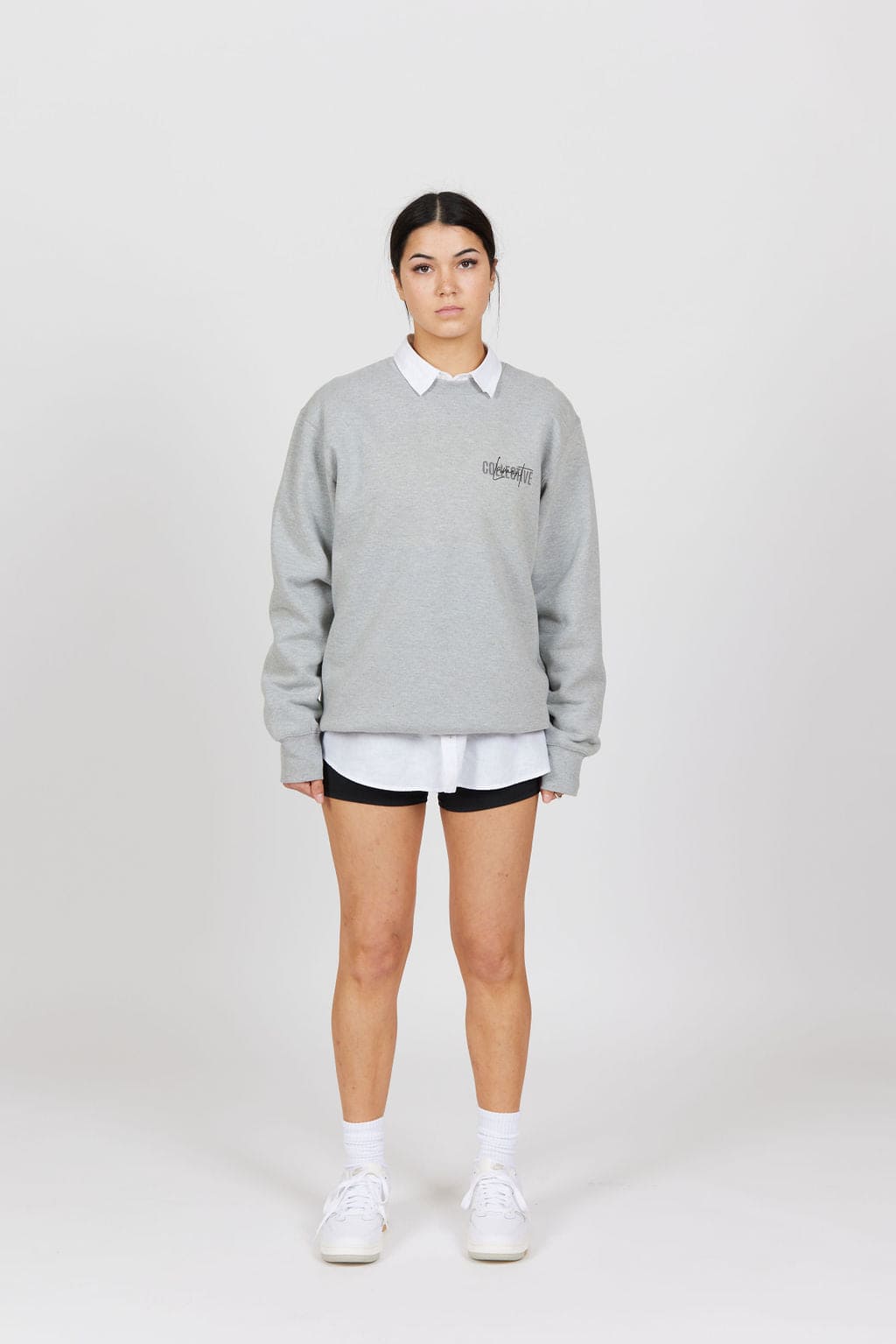 Front view of female model wearing the Grey Marl Collective Crew Neck Top