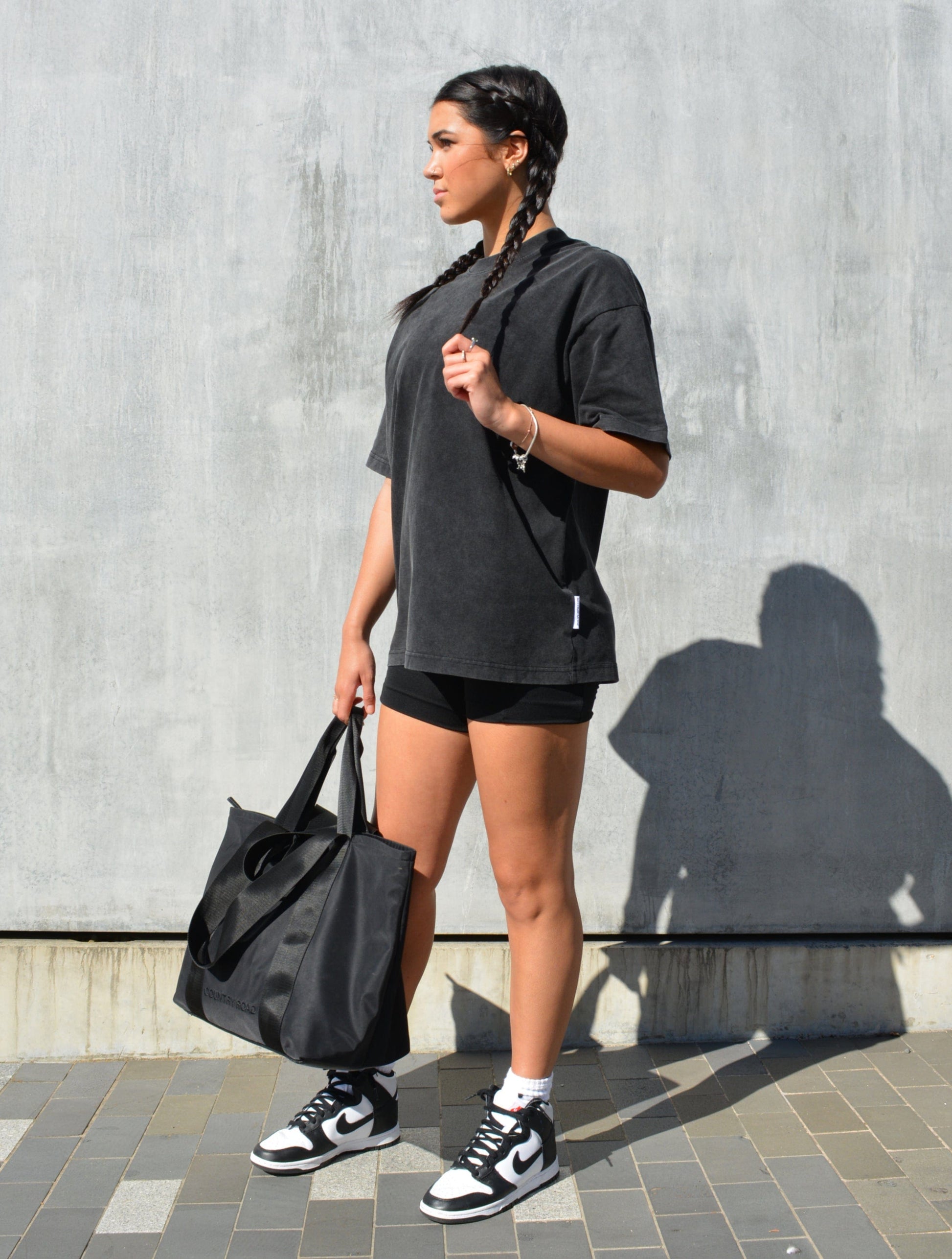 Still image of our Female model wearing our Black Washed Staple Tee